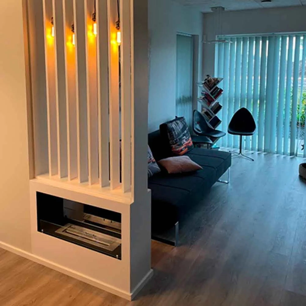 Lansing bioethanol fireplace used as a stylish room divider in a modern living space with vibrant lighting.