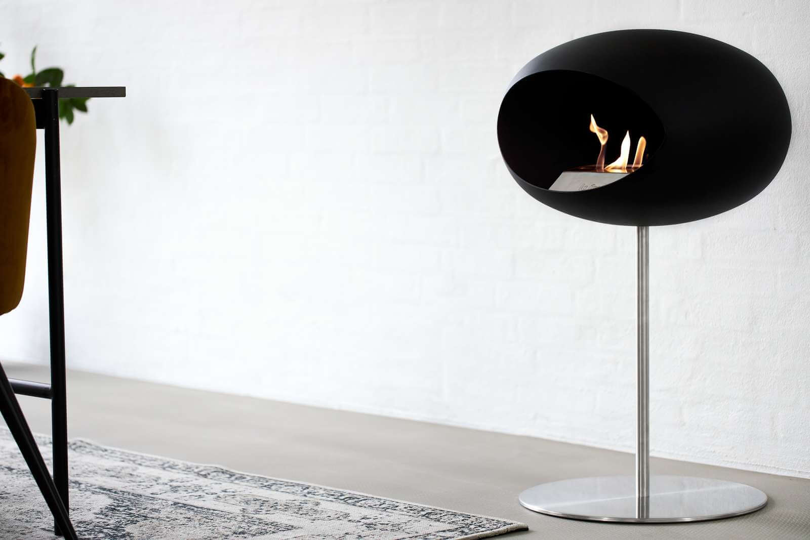 Le Feu Dome freestanding bioethanol fireplace in black, designed for indoor elegance and eco-friendly warmth.