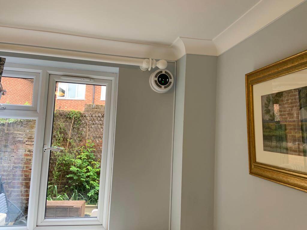 Heat recovery ventilator installed in a room, enhancing fresh air and energy efficiency.