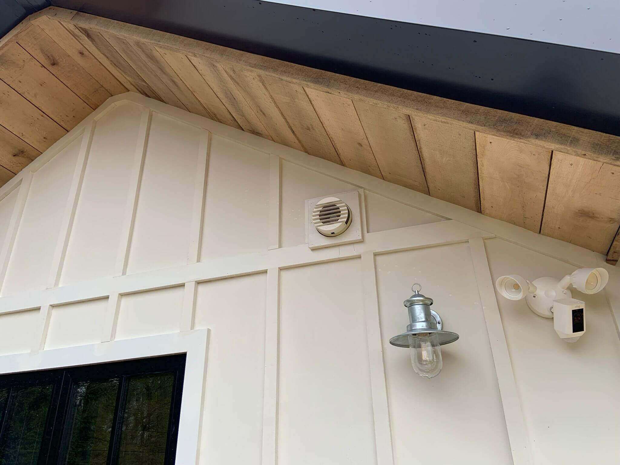 Close-up of the exterior wall with a ventilation system and decorative lighting features.