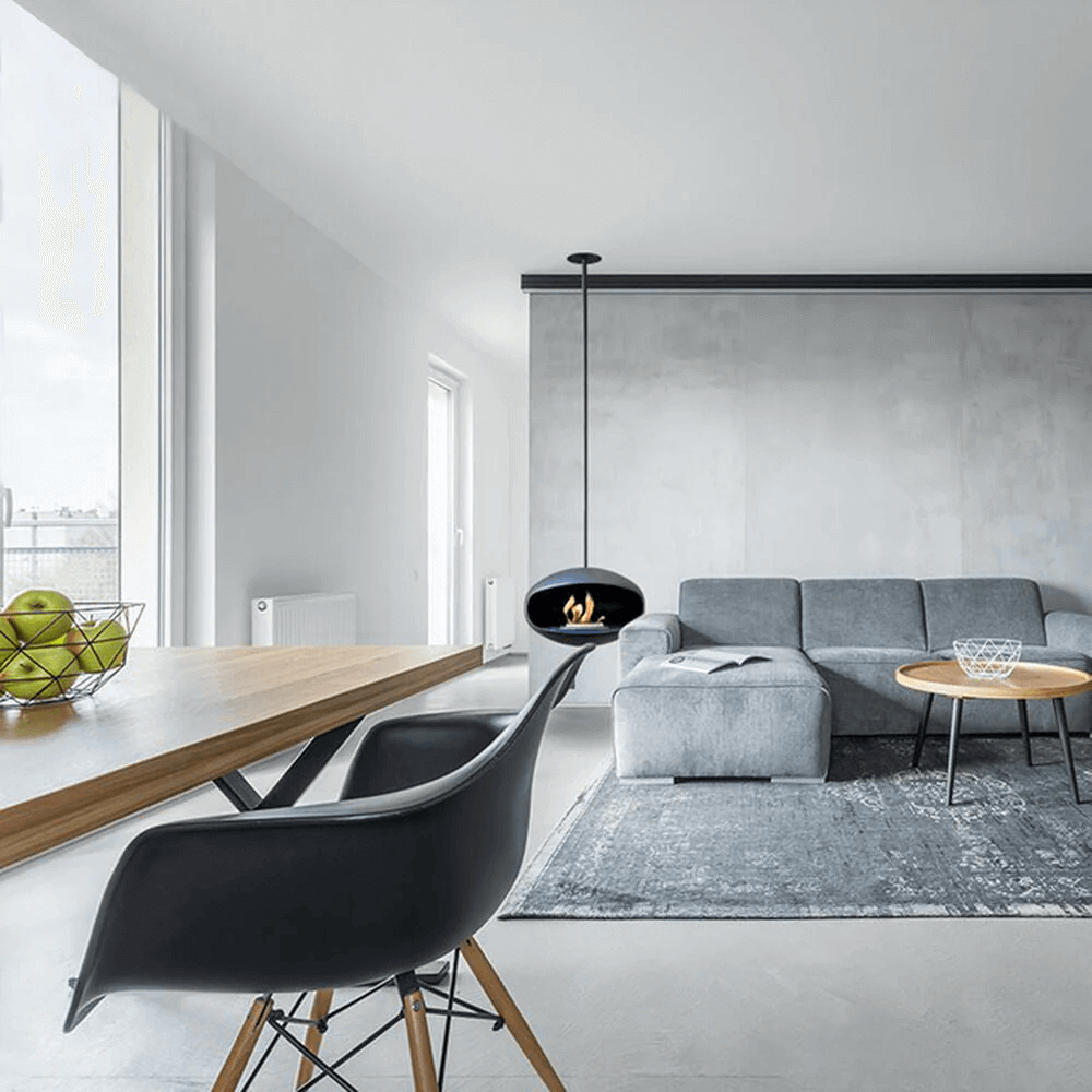 Modern living room featuring a Cocoon Aeris bioethanol fireplace, stylish furniture, and a minimalistic design.