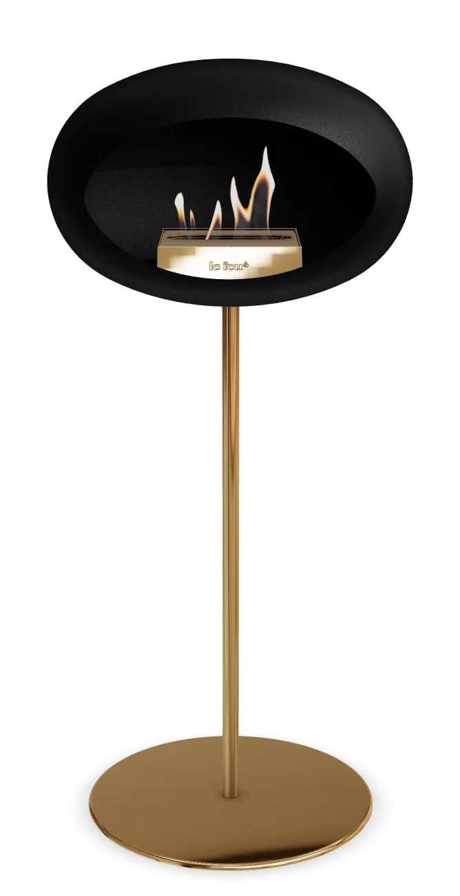 Freestanding black bioethanol fireplace with a gold base, perfect for contemporary indoor or outdoor settings.