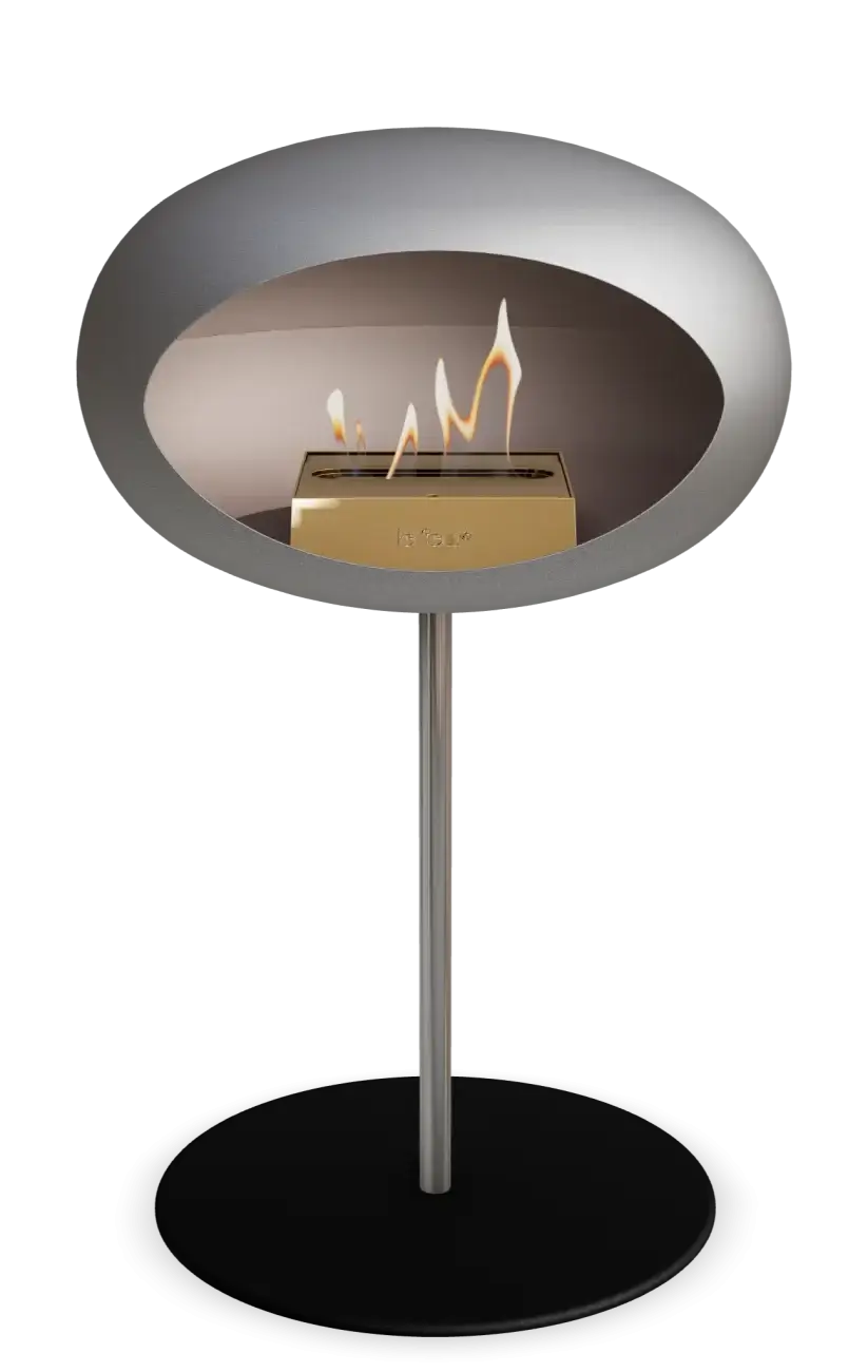 Stylish Le Feu Dome Ground Low Steel Bioethanol Fireplace with flames, perfect for contemporary indoor and outdoor spaces.