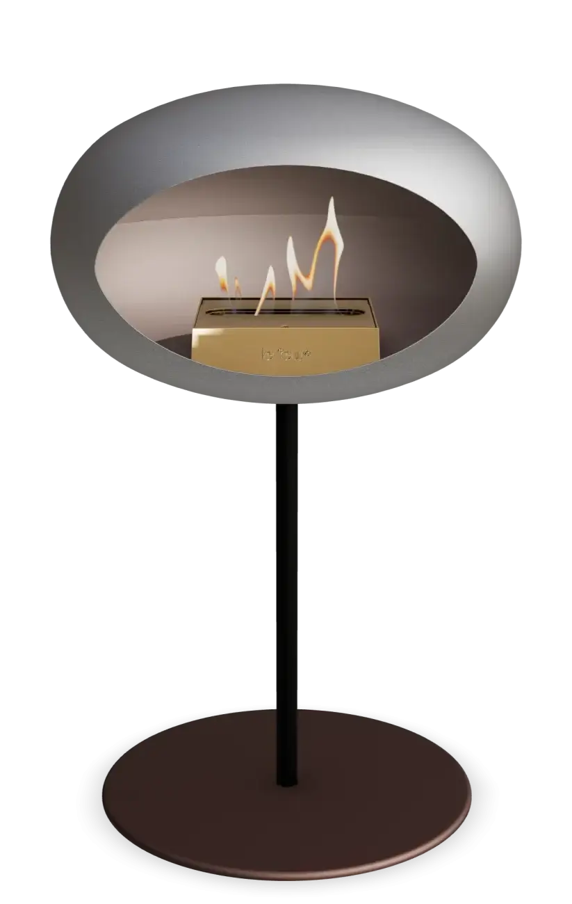 Freestanding Le Feu Dome Low Steel bioethanol fireplace in nickel with flame for modern indoor and outdoor decor.