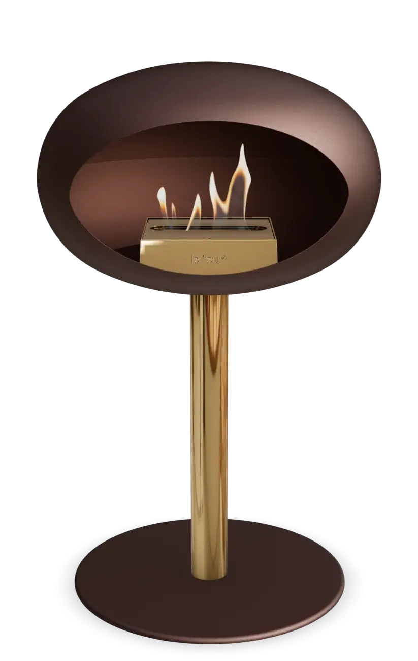 Freestanding Le Feu Dome Low Steel Bioethanol Fireplace in Mocca with a stylish gold base and flame.
