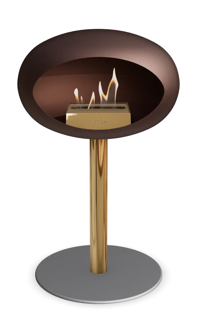 Freestanding bioethanol fireplace Le Feu Dome in mocca, modern design with golden accents and vibrant flames.