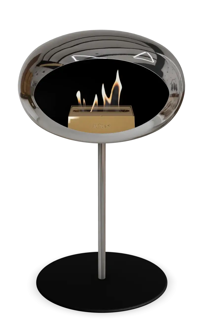 Freestanding bioethanol fireplace Le Feu Dome in chromed silver design, showcasing flames in a modern, stylish setting.