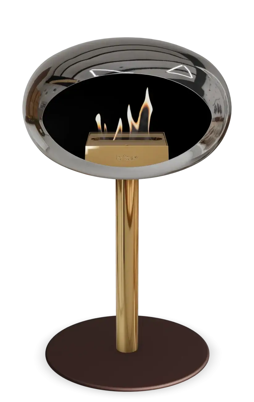 Stylish Le Feu Dome Ground Low Steel Bio Ethanol Fireplace in Chromed Silver with golden stand and flames.
