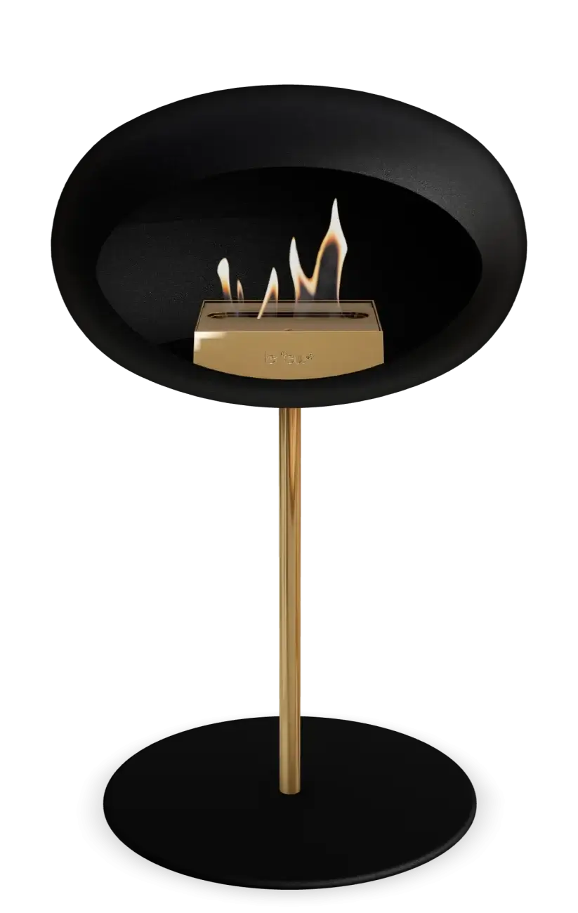 Freestanding black bioethanol fireplace Le Feu Dome Ground Low Steel with elegant gold accent.