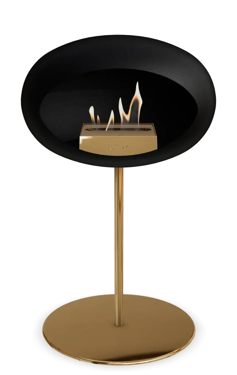 Freestanding black bioethanol fireplace with stylish gold base and flame, perfect for modern indoor or outdoor decor.