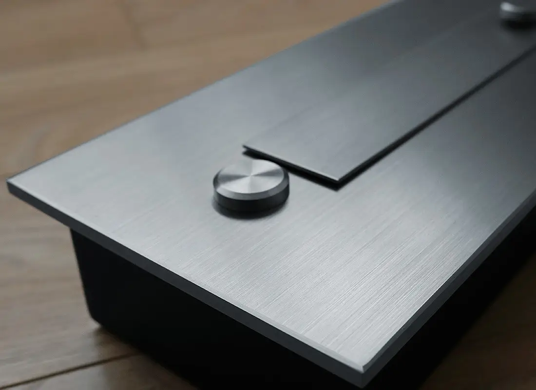 Close-up of the automatic bioethanol fireplace DALEX 1400 steel control panel with sleek stainless steel finish.