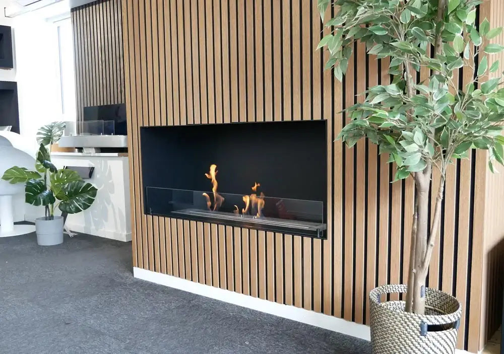 Modern bioethanol fireplace insert in stylish interior, showcasing flames through tempered glass.
