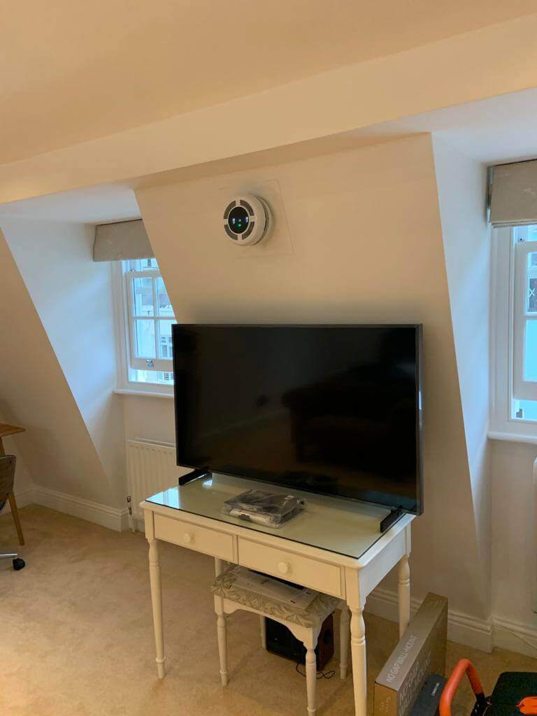 Living room featuring a heat recovery ventilator, enhancing indoor air quality with quiet ventilation.