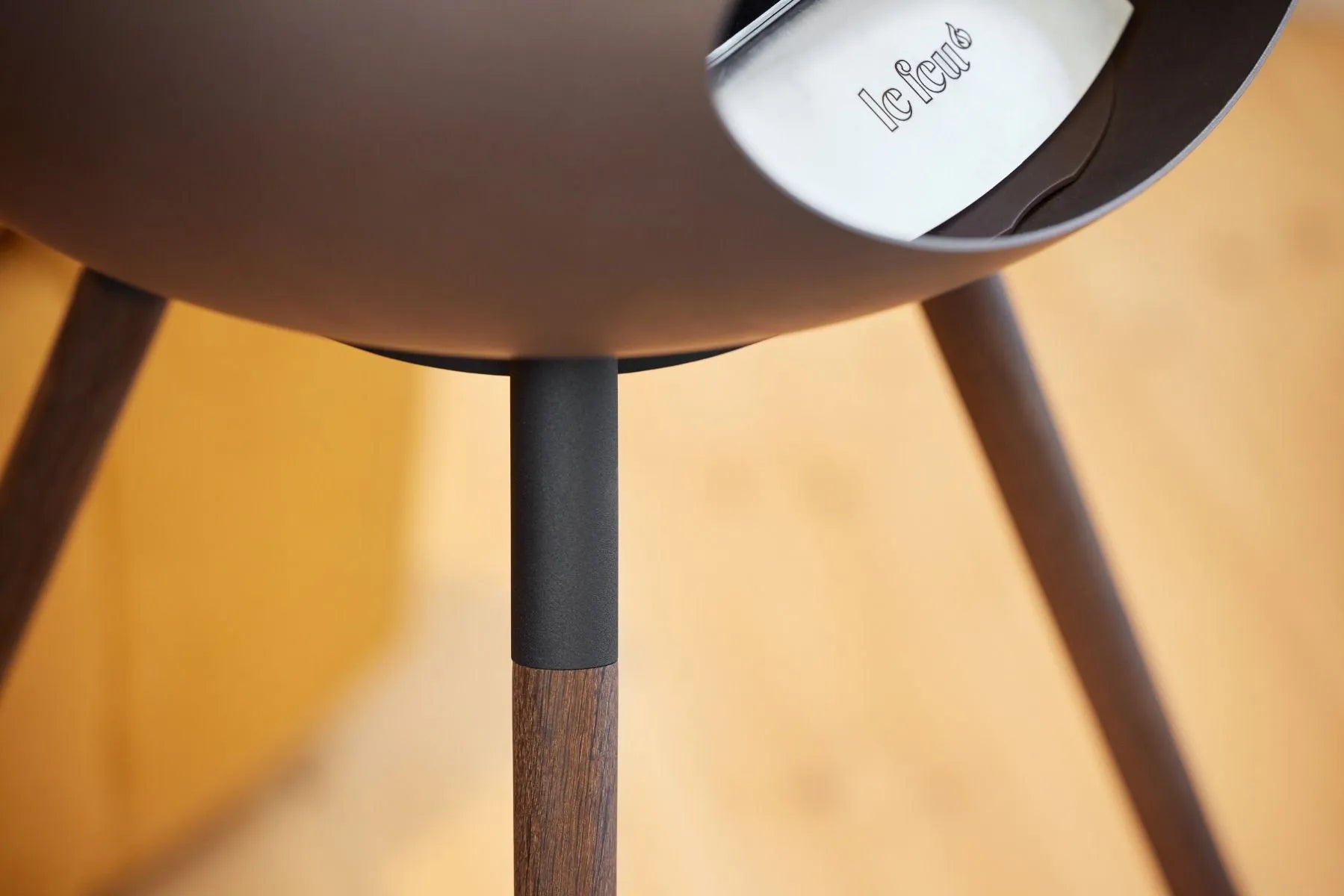 Close-up of the stylish legs and design of the Le Feu Dome Ground Low Bioethanol Fireplace.