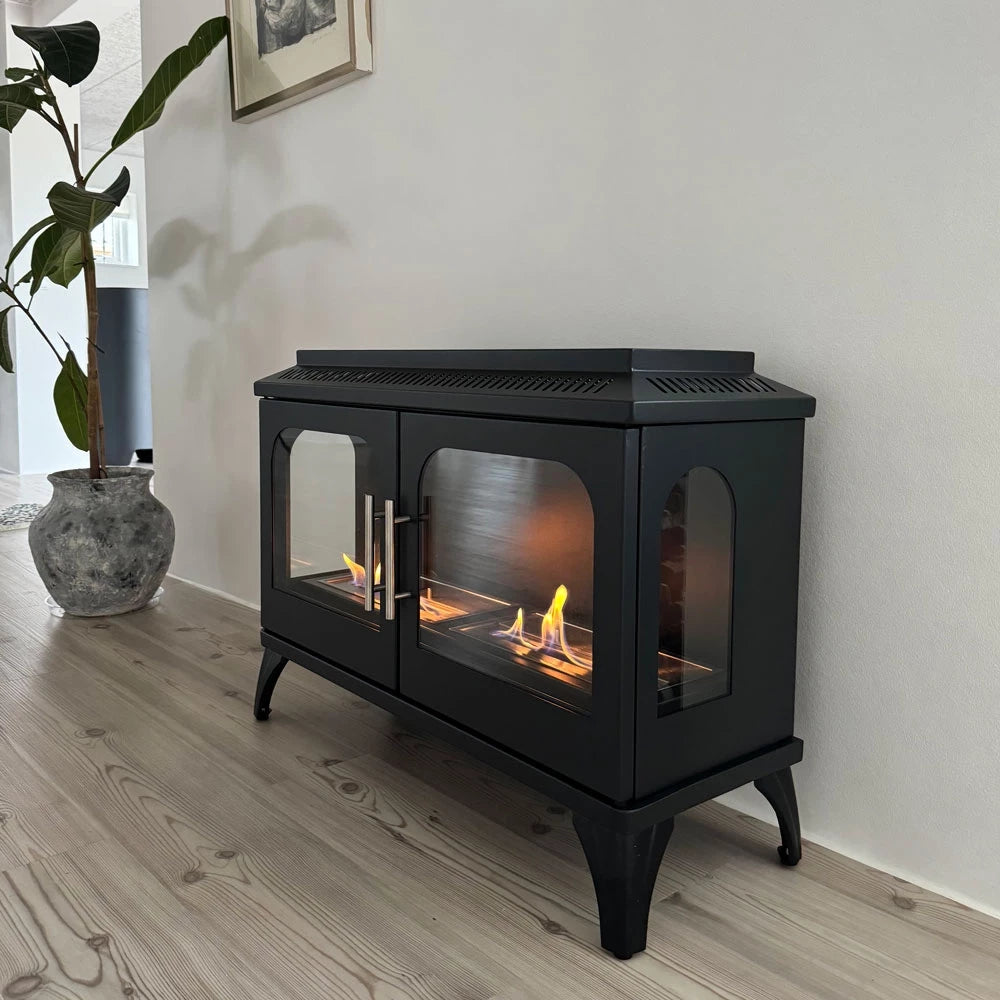Atlanta Double bioethanol stove by ScandiFlames with double doors and flames visible, set in a modern interior.