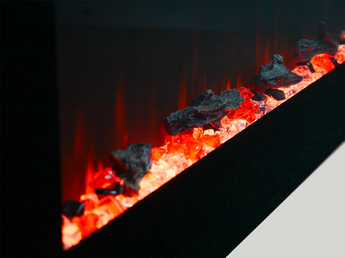 Close-up of the ScandiFlames Azurite electric fireplace glowing with realistic flame effects and decorative rocks.