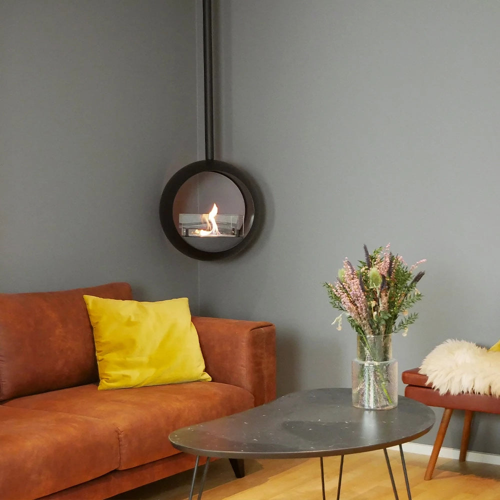 Edmonton 2-sided suspended bioethanol fireplace showcased in modern living room with cozy brown couch and elegant decor.