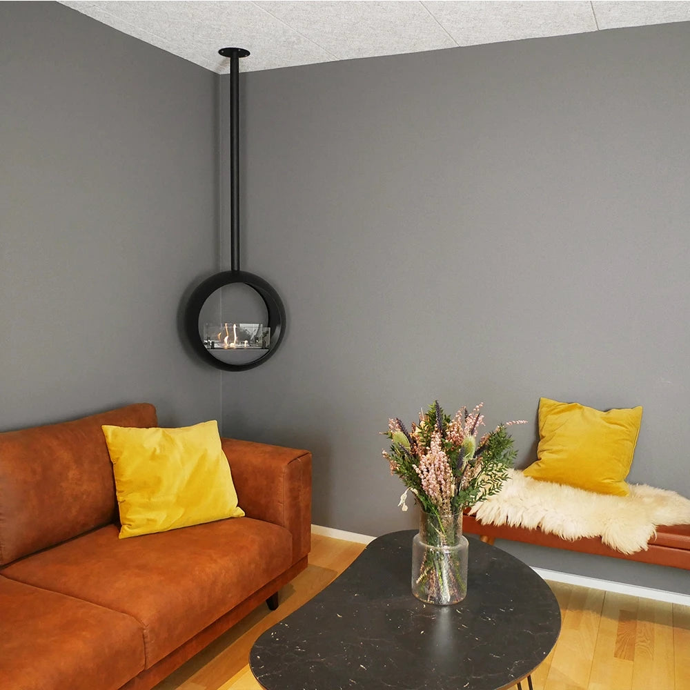 Edmonton 2-sided suspended bioethanol fireplace in modern living room with brown sofa and decorative pillows.