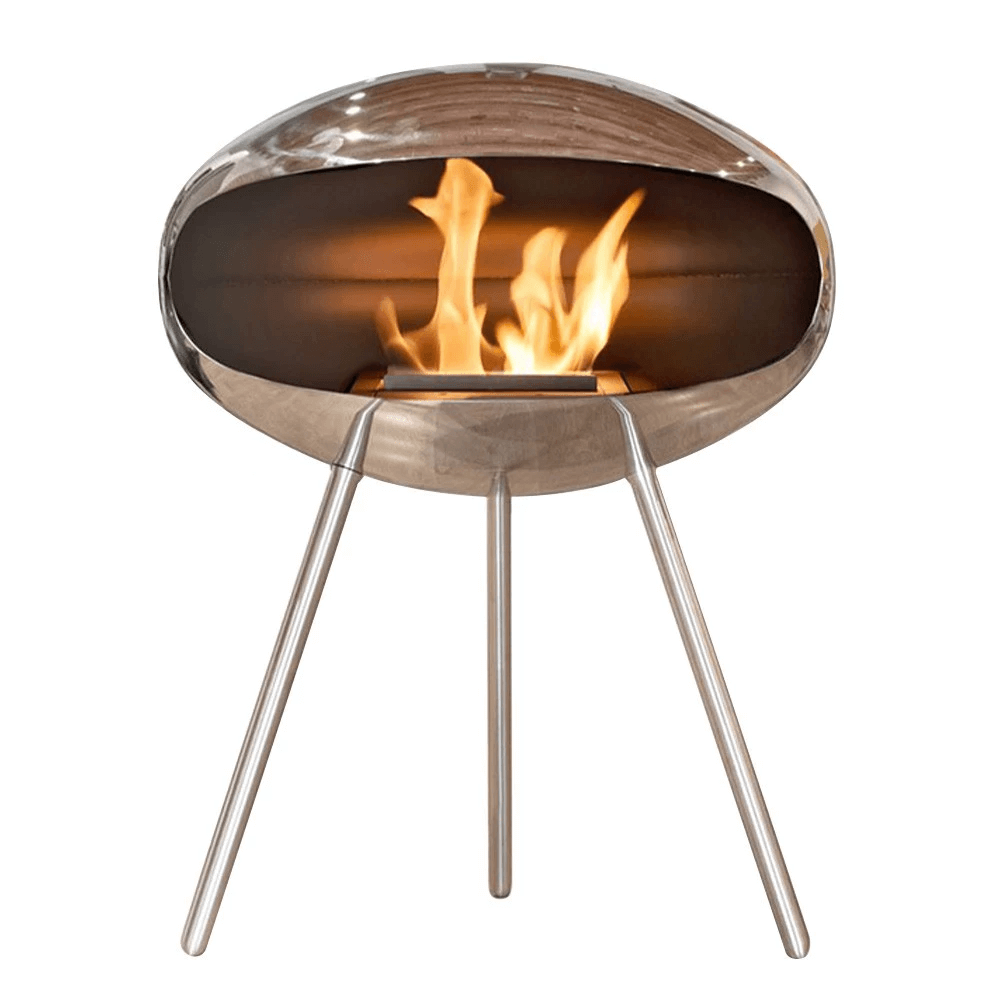 Cocoon Terra bioethanol fireplace in polished steel with modern three-legged design, showcasing flame.