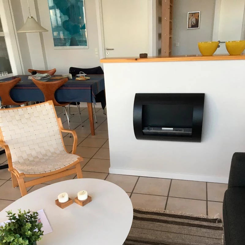 Stylish black wall-mounted bio fireplace in a modern living room setting with wooden accents.