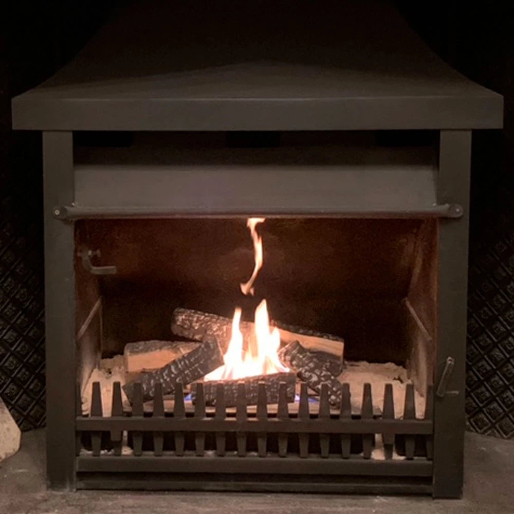 Bio fireplace showcasing ceramic wood logs with flames, creating a warm and cozy ambiance.