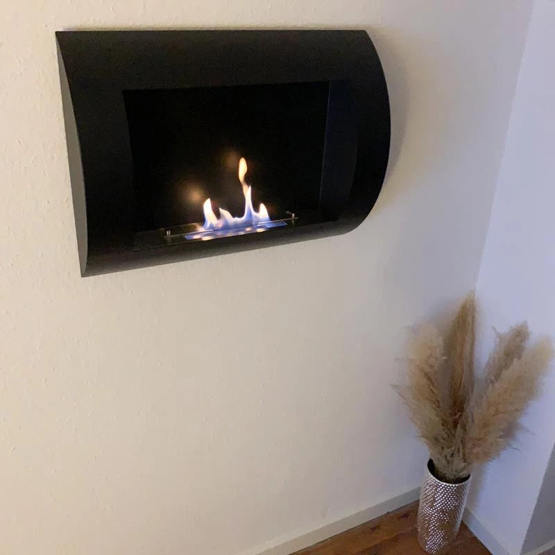 Ocean black bio wall fireplace featuring a modern curved design with flames, enhancing contemporary home decor.