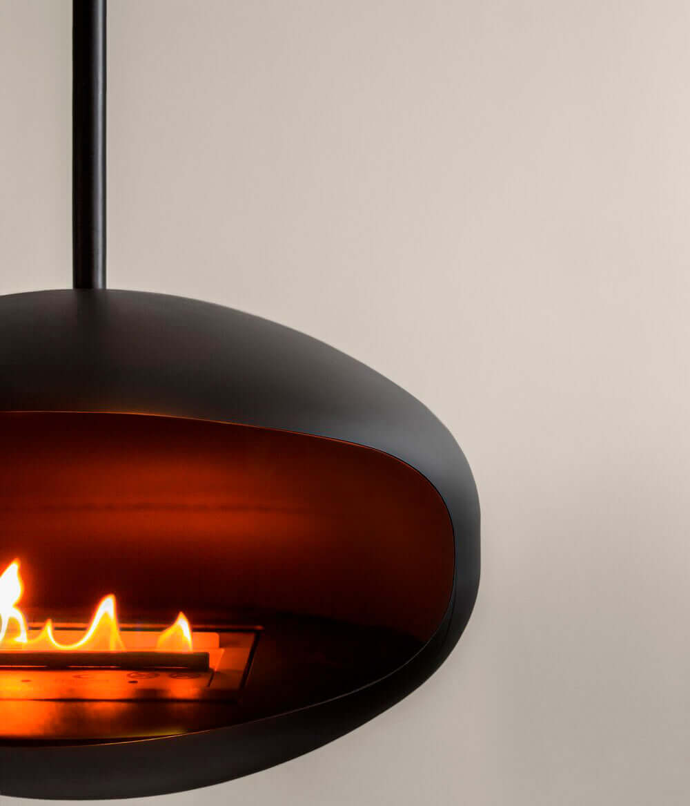 Cocoon Aeris matte black bioethanol fireplace showcasing elegant flames for modern living spaces.