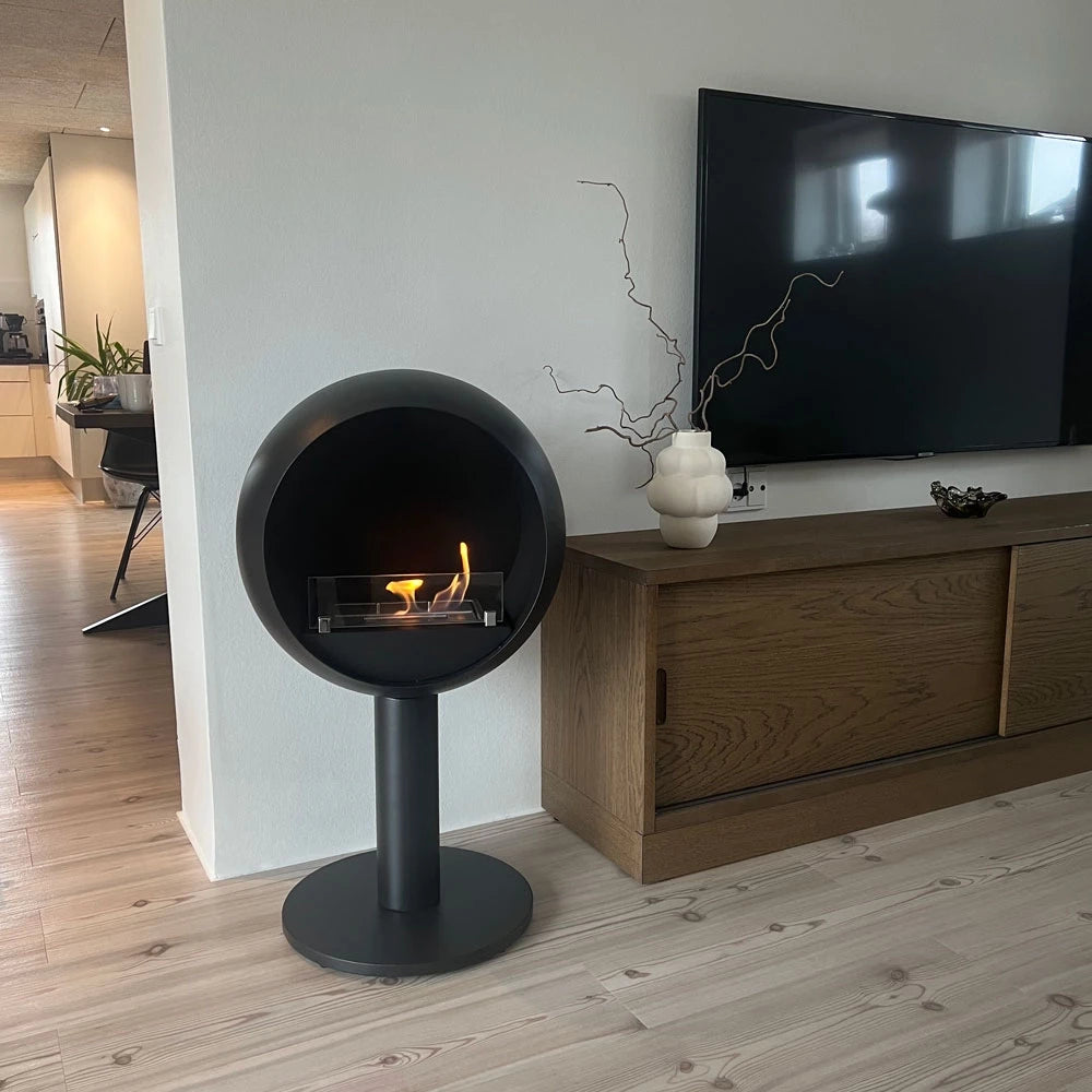 Edmonton freestanding bioethanol fireplace in modern living room featuring a sleek black round design.