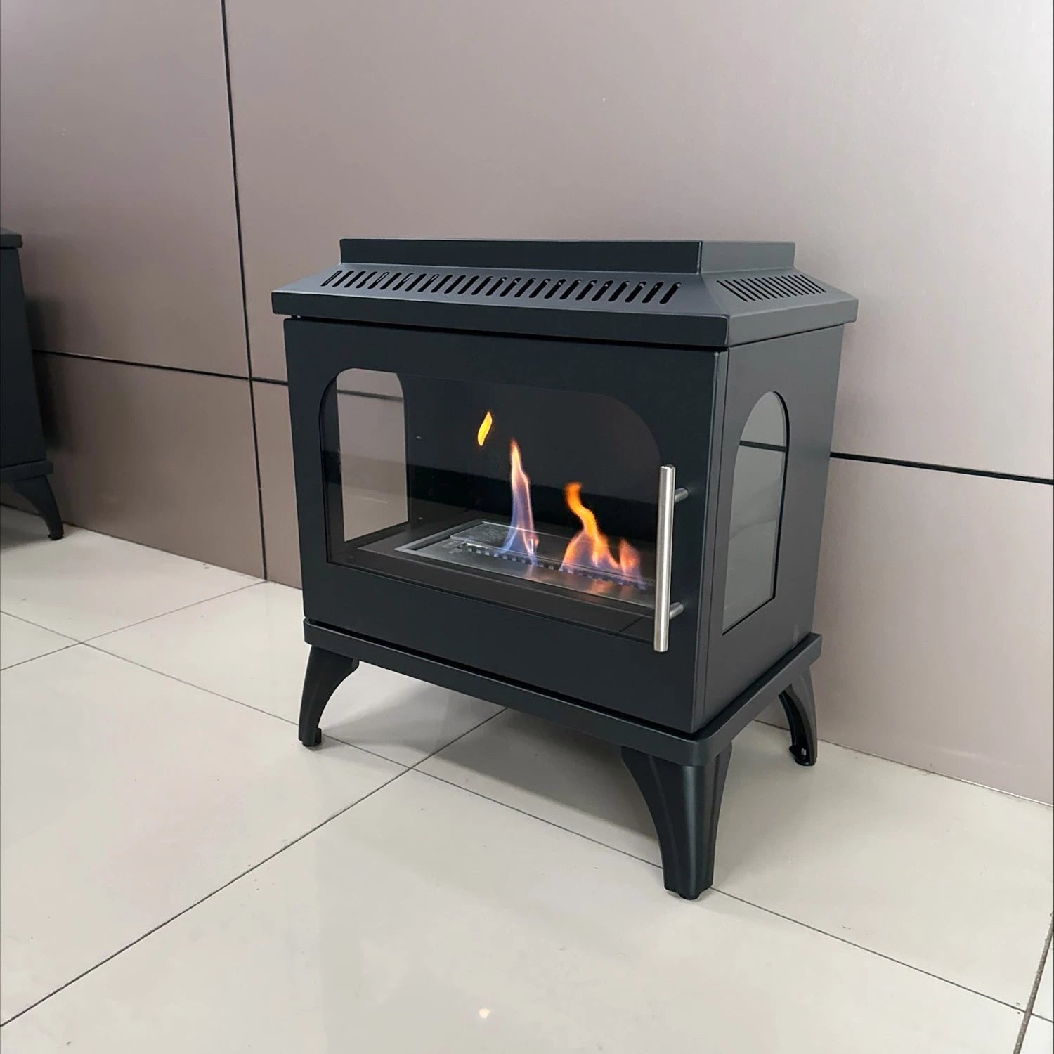 Atlanta Single Bioethanol Stove with flames, modern steel design, and glass windows for contemporary living spaces.