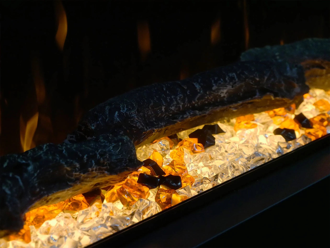 Close-up of ScandiFlames Feroza electric fireplace with realistic flames and decorative glass stones.