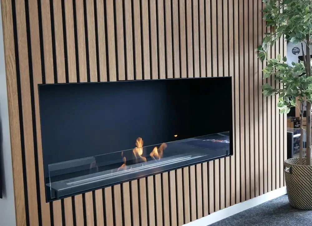 Built-in bioethanol fireplace Foco One 1000 showcasing a sleek design and flickering flames against a modern wooden wall.