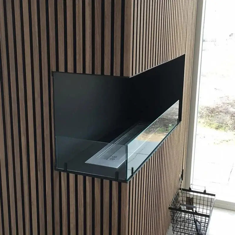 Bioethanol fireplace insert in a modern wooden wall, showcasing a sleek design with tempered glass.