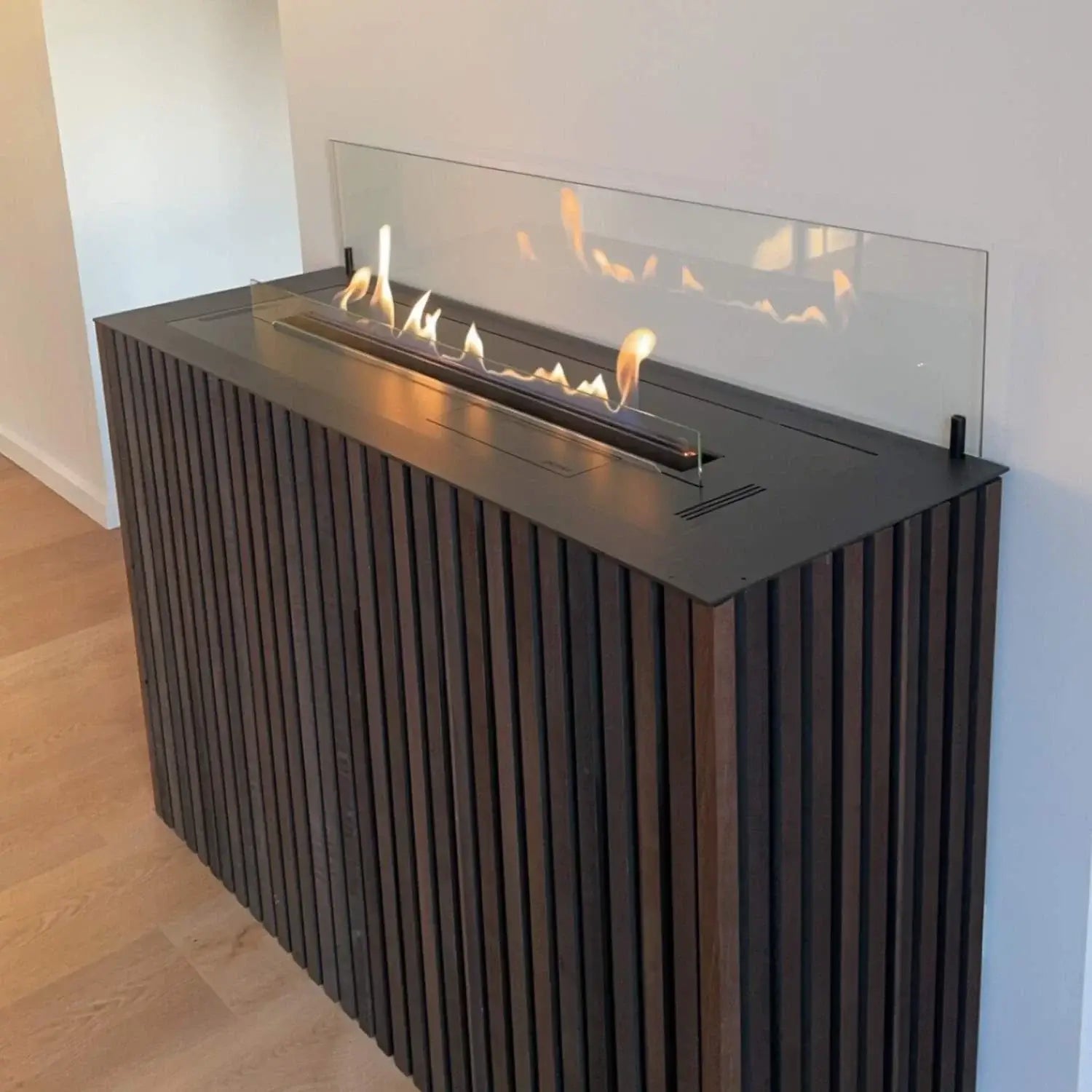 Modern bioethanol fireplace design with sleek glass and stainless steel featuring adjustable flames.