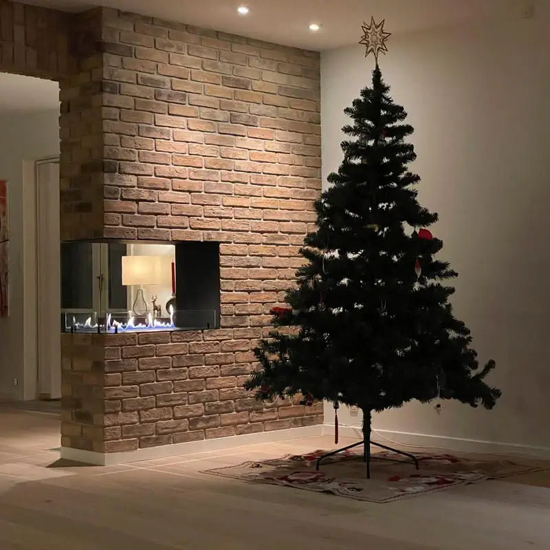 Modern living room with a Christmas tree and a bioethanol fireplace integrated into a stone wall.