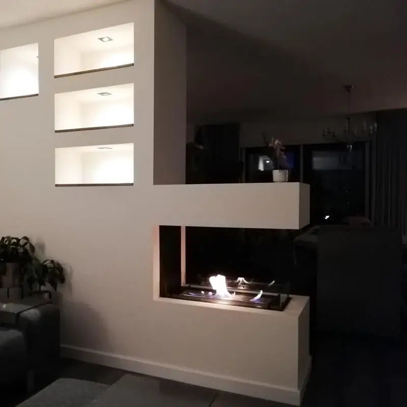 Modern bioethanol fireplace room divider with flame, integrated shelving, and minimalistic design.