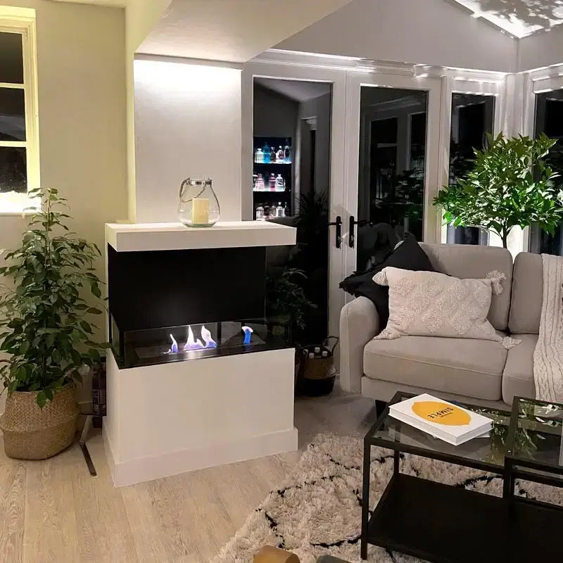 Modern bioethanol fireplace in a stylish living room, showcasing flames and sleek design with tempered glass panels.