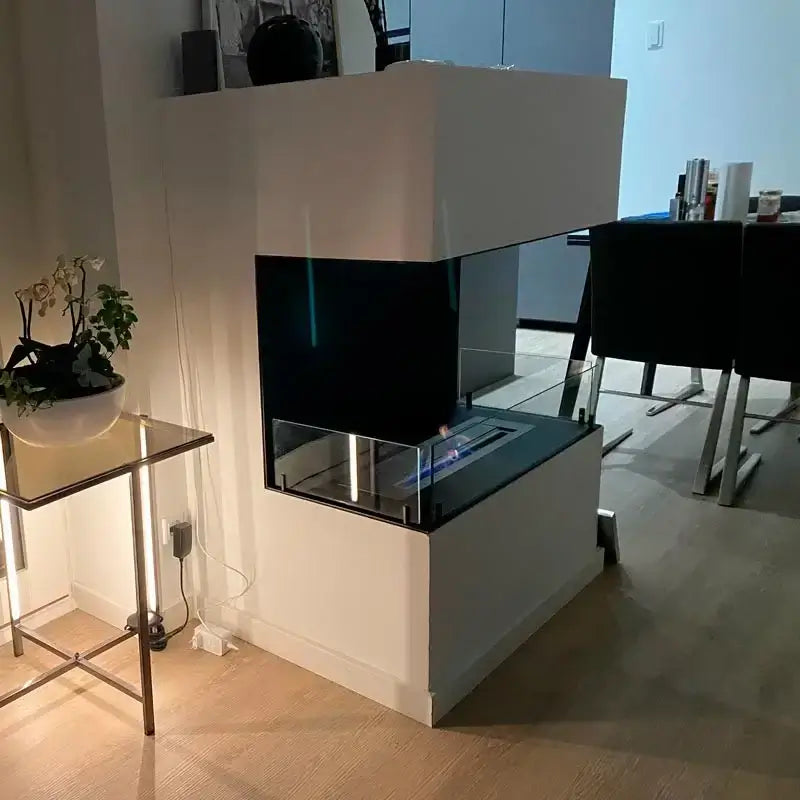 Modern bioethanol fireplace Foco Three 1000 with tempered glass panels in a stylish home setting.