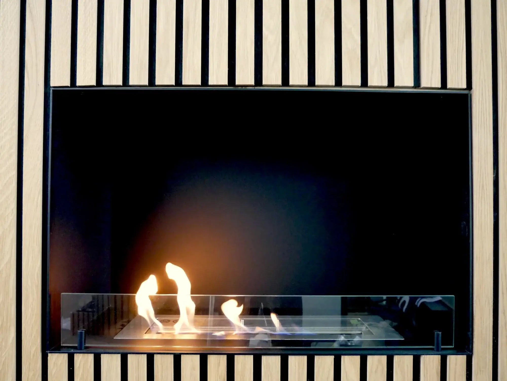 Stylish bioethanol fireplace Foco One 800 with flames visible through tempered glass, designed for modern interiors.