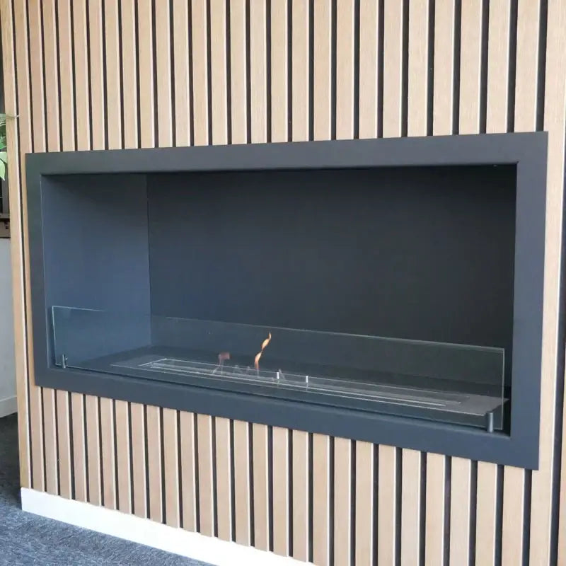 Stylish built-in bioethanol fireplace with glass front and modern black frame.