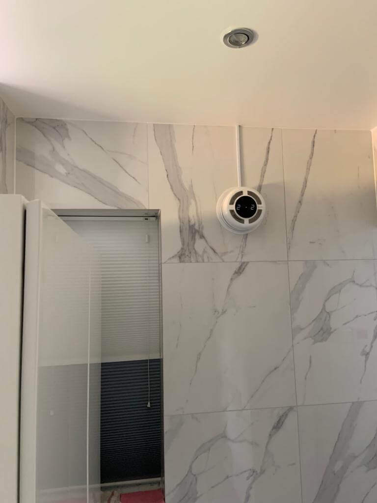 Heat recovery ventilator installed on a wall, designed for efficient ventilation in modern interiors.