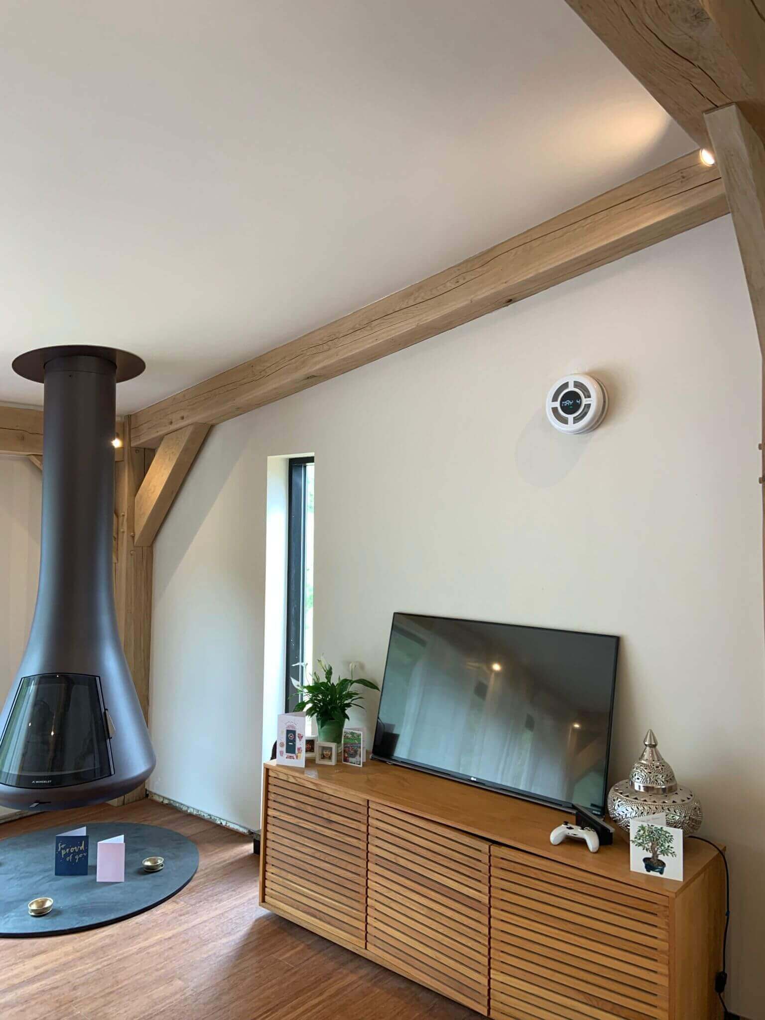 Modern living room featuring a heat recovery ventilator, stylish furniture, and a contemporary fireplace.