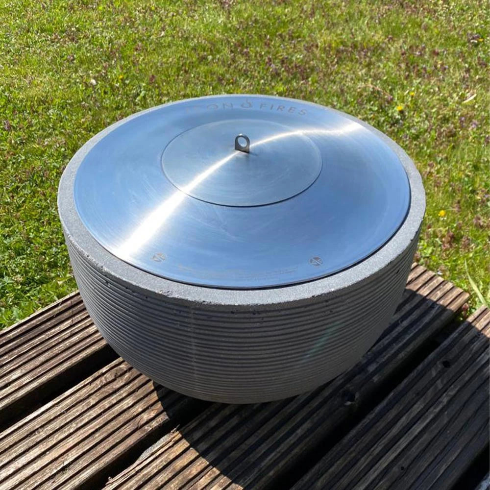 Icon Fires Round RD380 bioethanol burner in stainless steel, perfect for creating a cozy atmosphere outdoors.