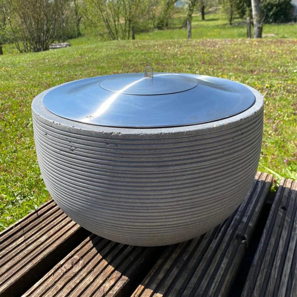 Icon Fires Round RD380 bioethanol burner in stainless steel on a wooden deck, designed for outdoor ambiance.
