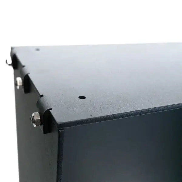 Close-up of the assembly of a bioethanol fireplace insert with black finished edges and metal fasteners.