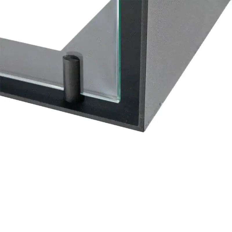 Close-up of the corner detail of a bioethanol fireplace insert with glass and metal frame.
