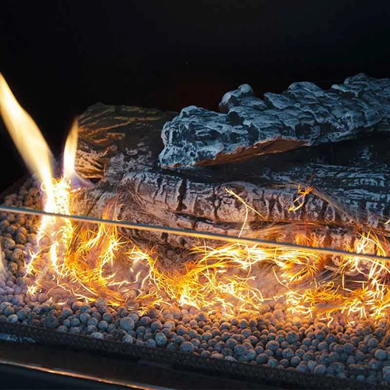 Glow Flame Fiber igniting in a bio fireplace, showcasing safe and eco-friendly flames on decorative rocks.