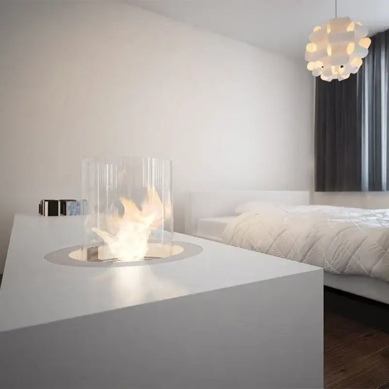 Modern Planika Rondo Commerce bio-ethanol fireplace insert in a stylish bedroom setting.