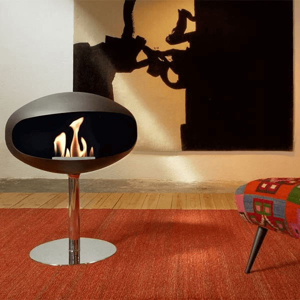 Cocoon Pedestal bioethanol fireplace in matte black, providing warmth and elegance in a modern setting.