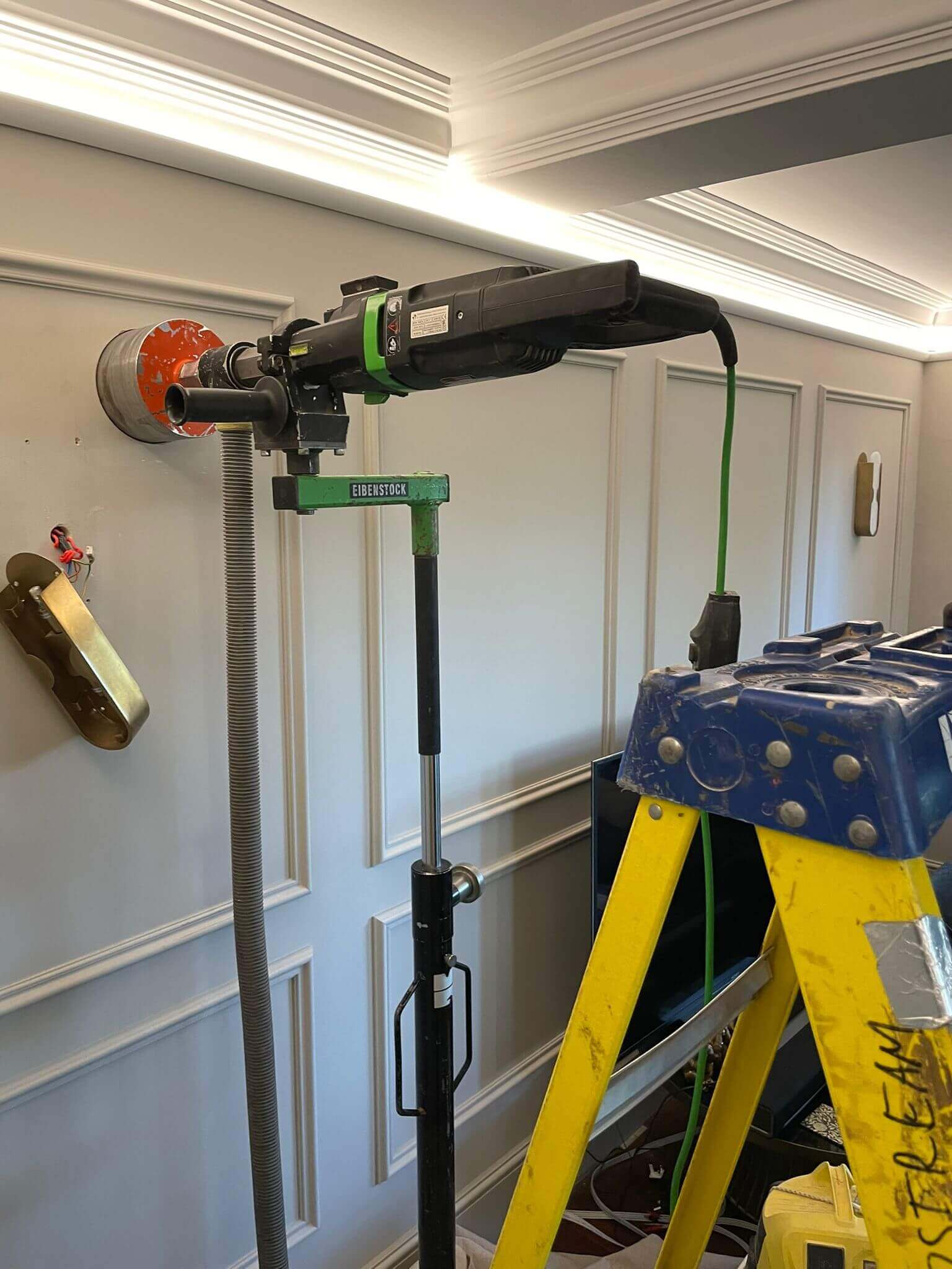 Heat recovery ventilation installation setup with tools and equipment on a ladder.