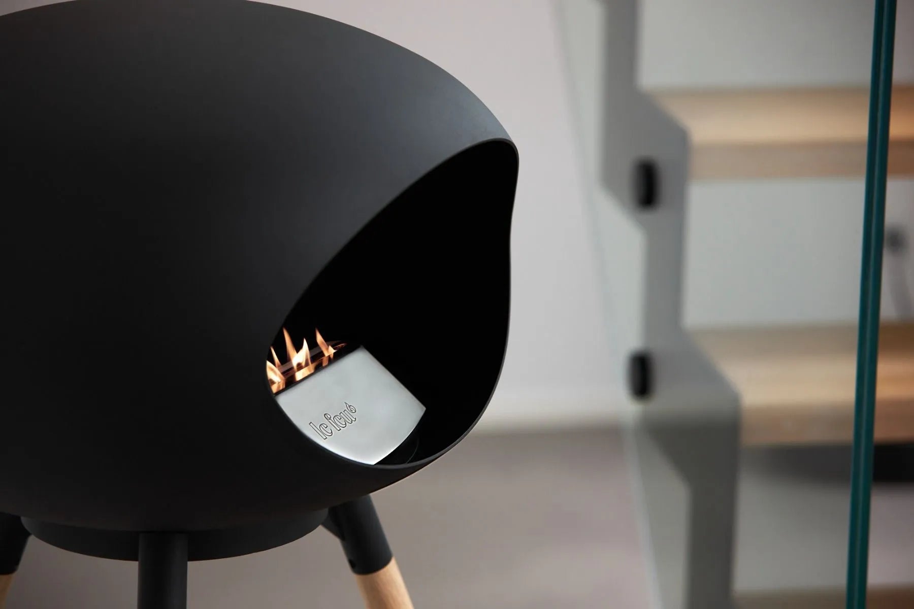 Le Feu Dome Ground Low Bioethanol Fireplace in black with flames, stylish and portable for any space.